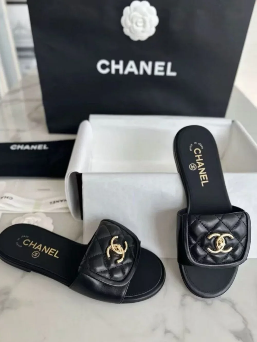 CHANEL Black Quilted Leather CC Turn‑Lock Flat Slide Sandals